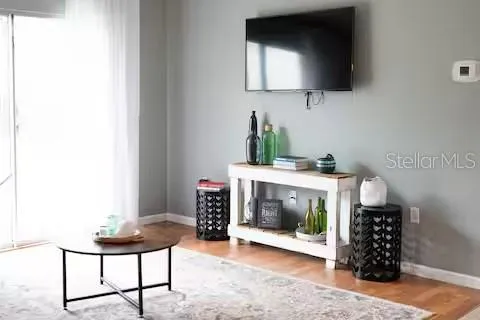 a living room with a fireplace and a flat screen tv