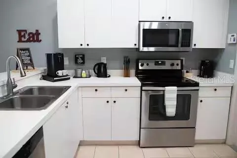 a kitchen with a sink stove and microwave