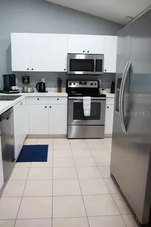 a kitchen with stainless steel appliances a stove a microwave and a sink