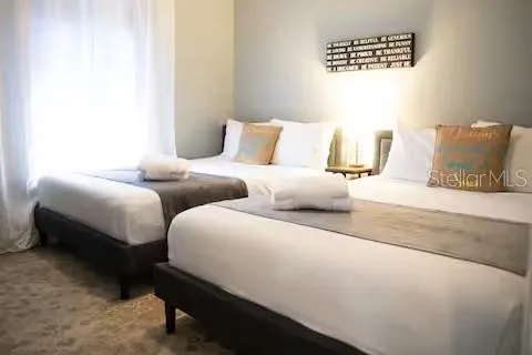 a bedroom with two beds and a couch