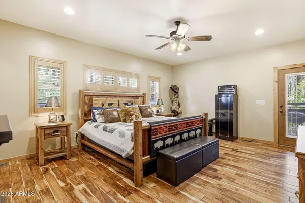 a kitchen with stainless steel appliances granite countertop a refrigerator a stove and a wooden floors