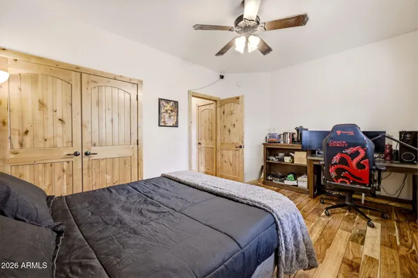 a spacious bedroom with a bed and a chandelier