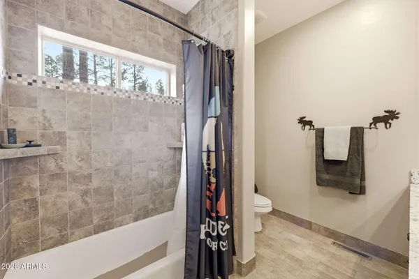 a bathroom with a granite countertop sink a large mirror and a shower