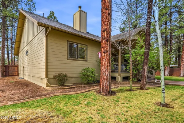 a backyard of a house with table and chairs