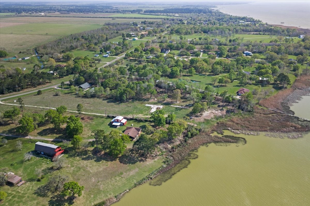 0 South Main Street Anahuac, TX 77514 - Photo 9 of 14 an aerial view of green landscape with trees houses and lake view