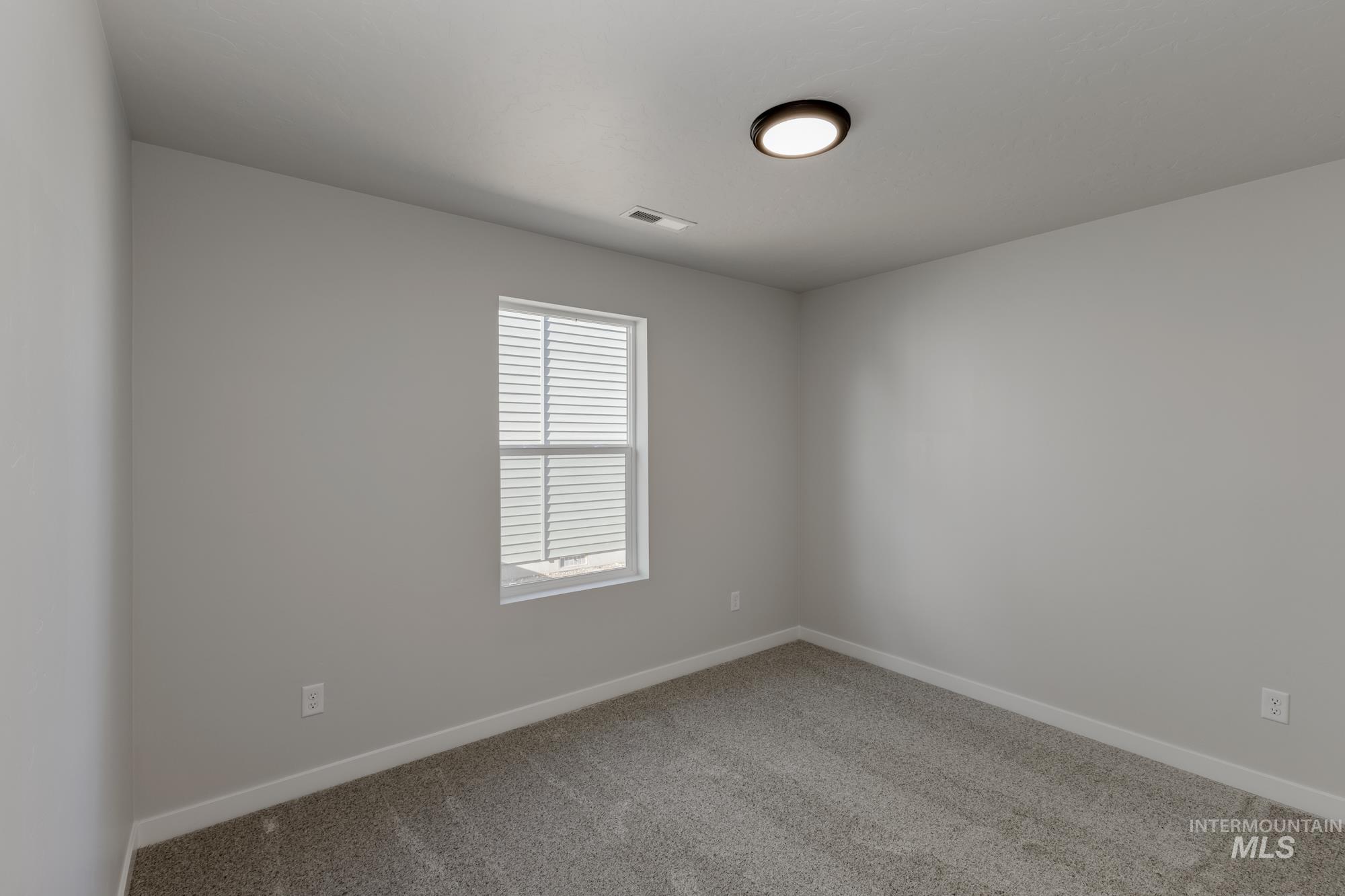 13337 Scrape Street Caldwell, ID 83607 - Photo 12 of 19 Recessed window with white blinds, neutral wall paint, and gray carpet flooring