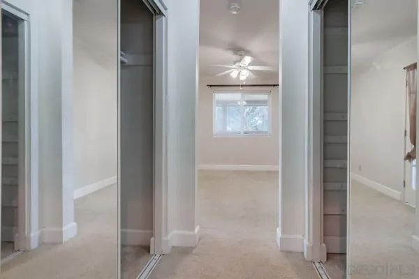 a room with wooden floor and cabinets