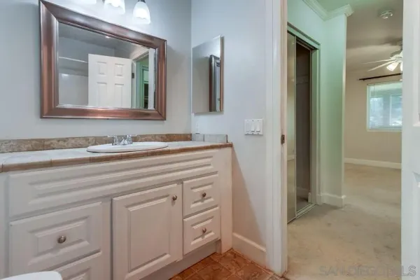 a bathroom with a sink vanity and mirror