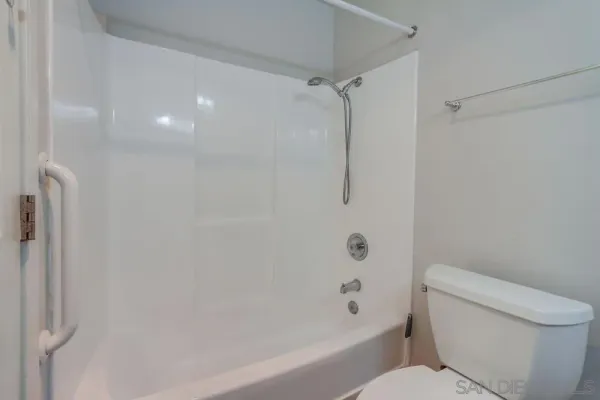 a bathroom with a toilet and a bathtub