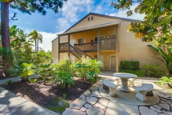 a view of a chair and table in backyard