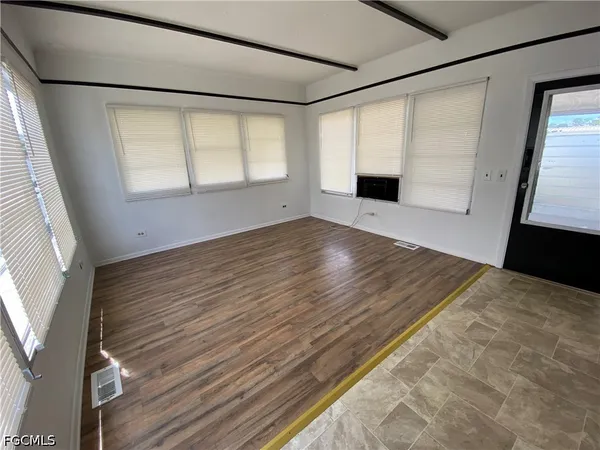 a bathroom with a bathtub a shower and a window