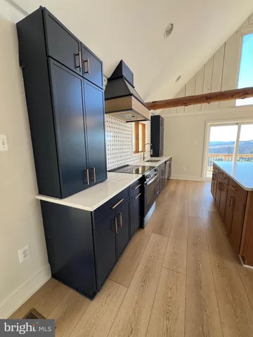 a kitchen with stainless steel appliances wooden cabinets a refrigerator and a stove