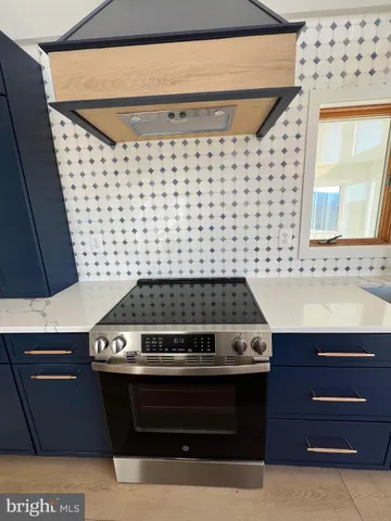 a stove top oven sitting inside of a kitchen