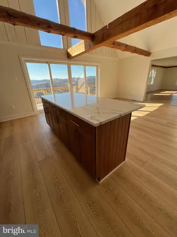 a kitchen with a sink and wooden floor