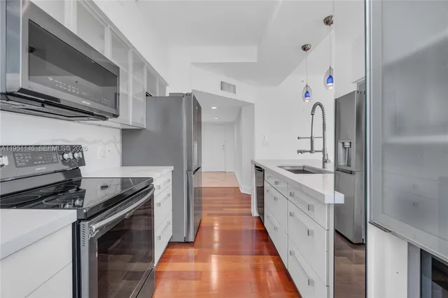 a kitchen with stainless steel appliances granite countertop a stove and a refrigerator