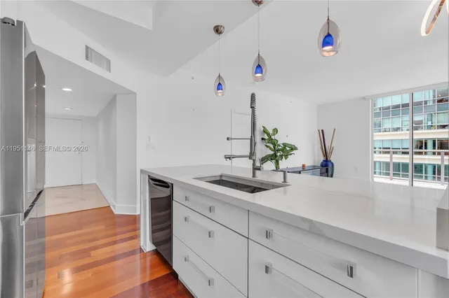 a kitchen with stainless steel appliances a stove a microwave and a refrigerator