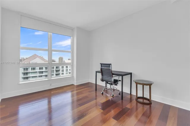 a view of a workspace with wooden floor