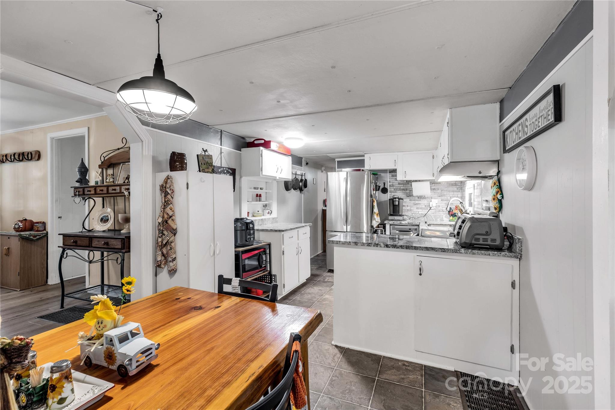 1164 Stroupe Road Lancaster, SC 29720 - Photo 16 of 37 a kitchen with stainless steel appliances wooden floor dining table and chairs