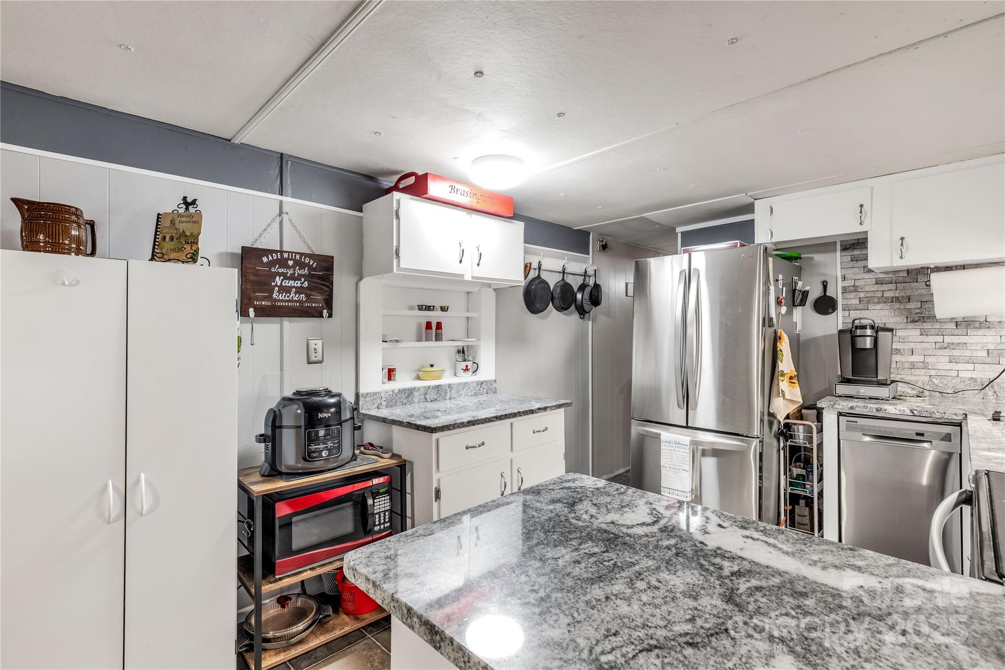 1164 Stroupe Road Lancaster, SC 29720 - Photo 17 of 37 a kitchen with stainless steel appliances granite countertop a refrigerator and a stove top oven
