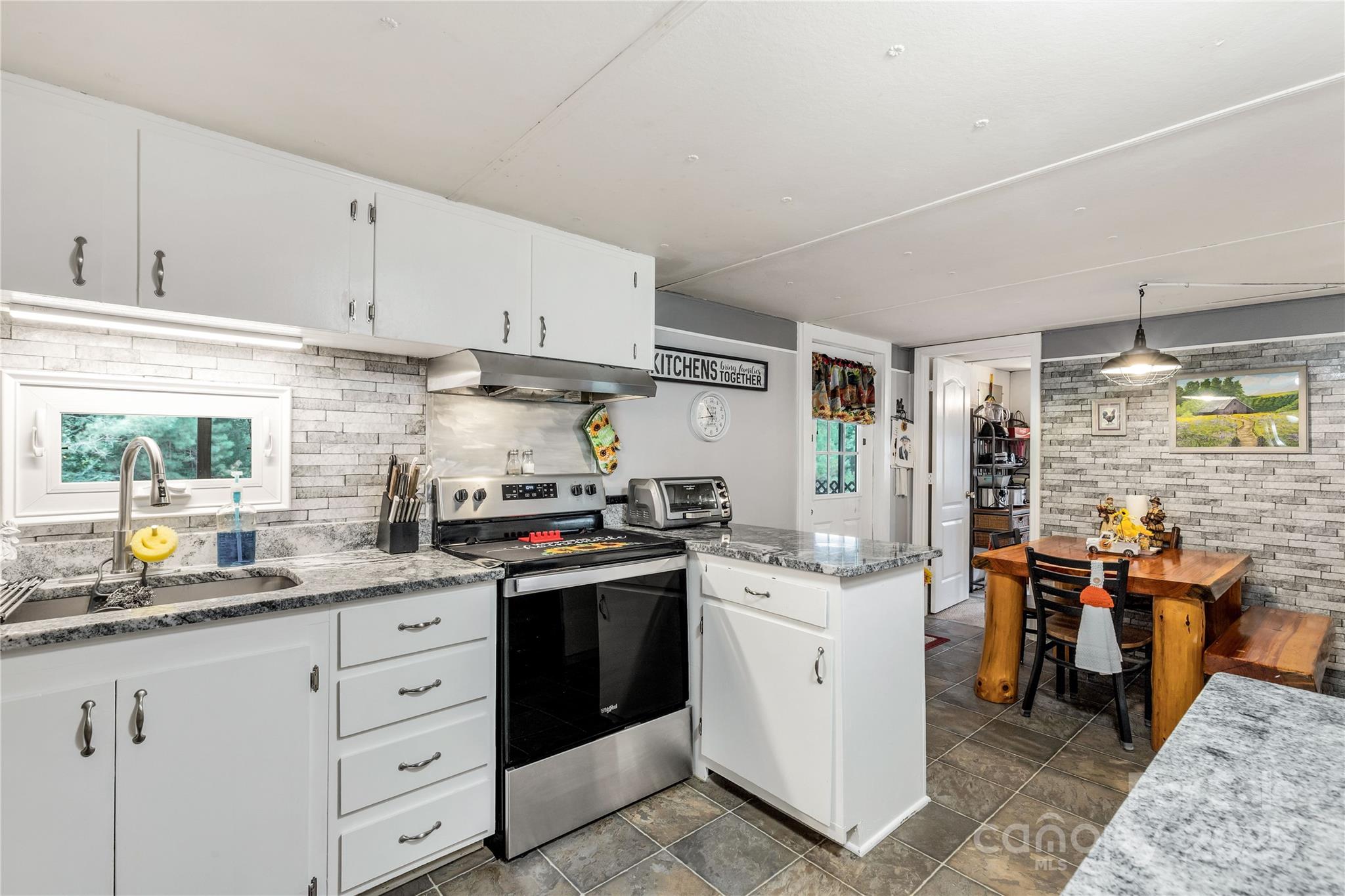 1164 Stroupe Road Lancaster, SC 29720 - Photo 19 of 37 a kitchen with stainless steel appliances granite countertop a sink stove and refrigerator