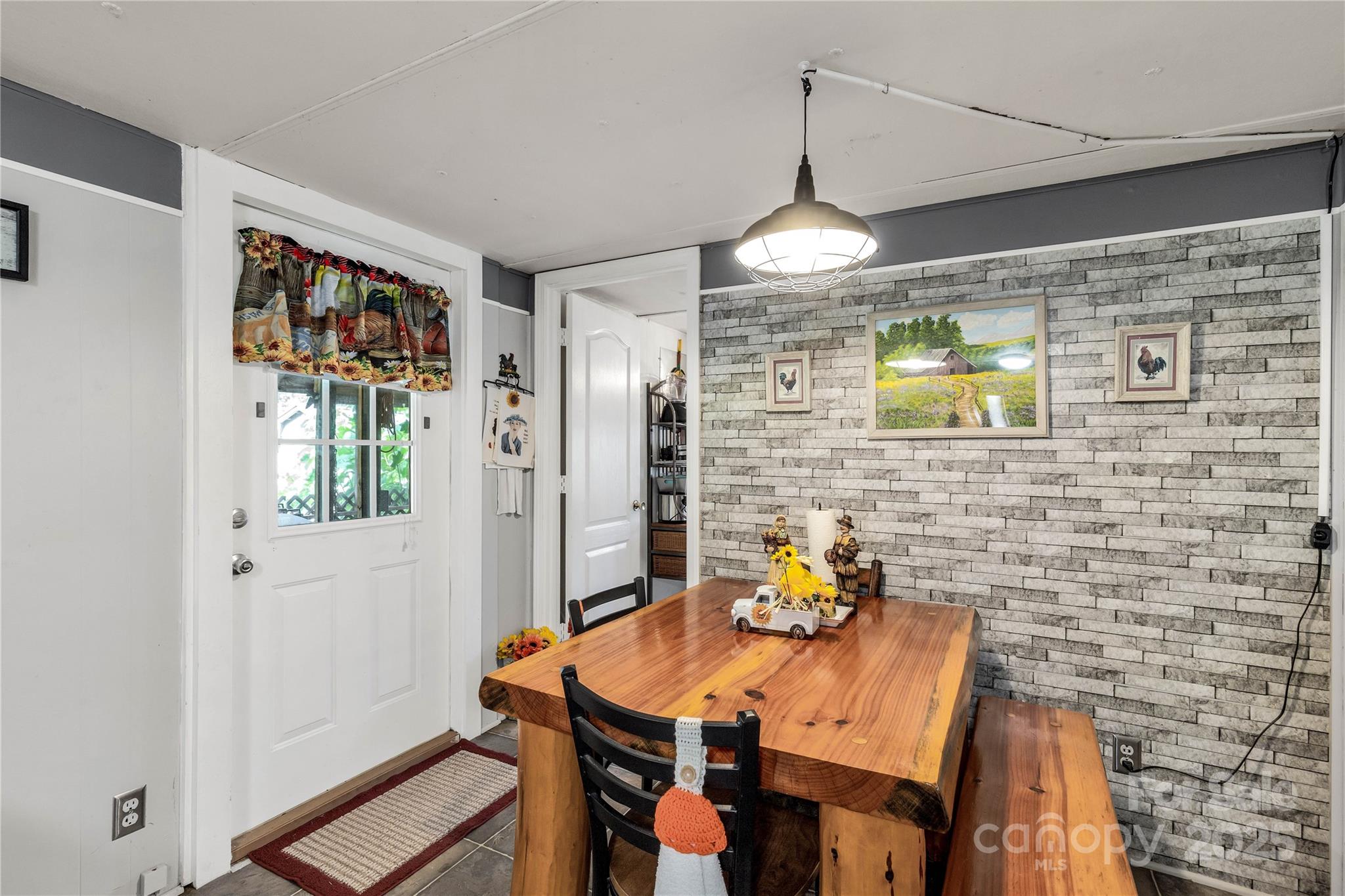 1164 Stroupe Road Lancaster, SC 29720 - Photo 23 of 37 a view of a dining room with furniture a chandelier and wooden floor