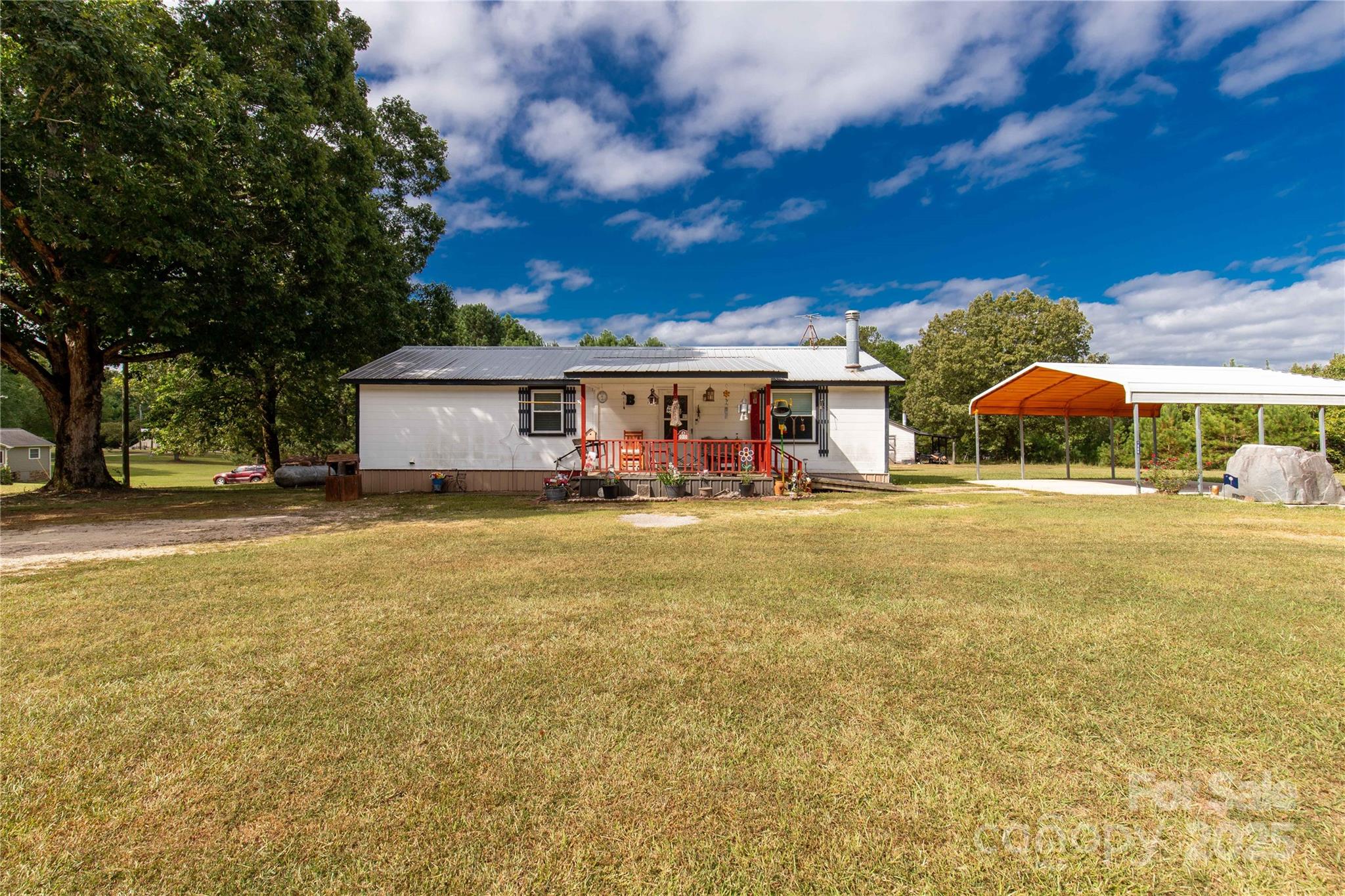1164 Stroupe Road Lancaster, SC 29720 - Photo 27 of 37 a house view with swimming pool and trees