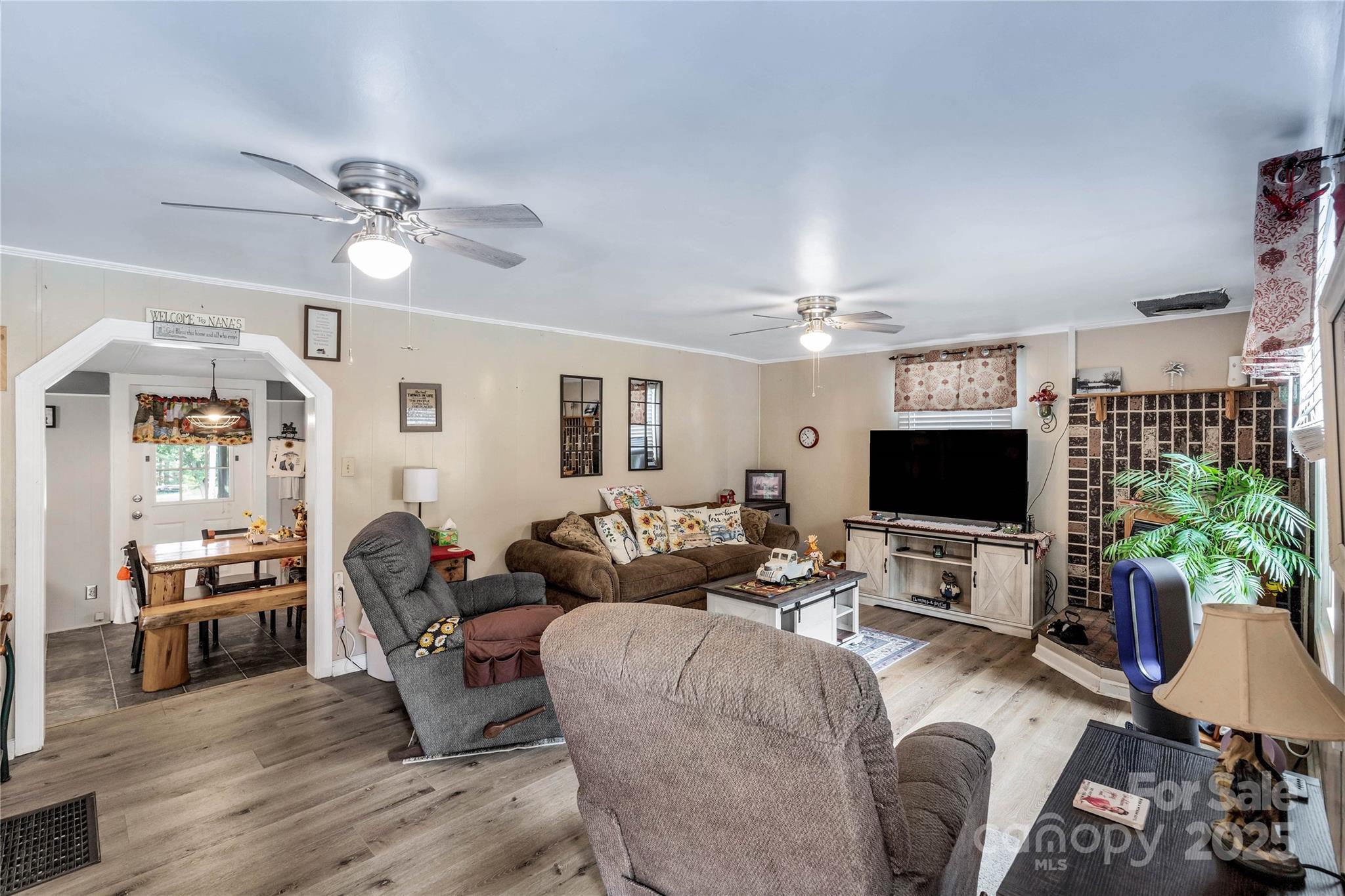1164 Stroupe Road Lancaster, SC 29720 - Photo 9 of 37 a living room with furniture a dining table a lamp and a flat screen tv