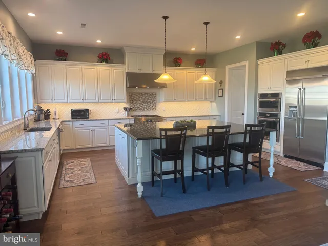 a kitchen with granite countertop sink and cabinets