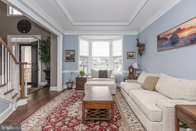a living room with furniture a table and a large window