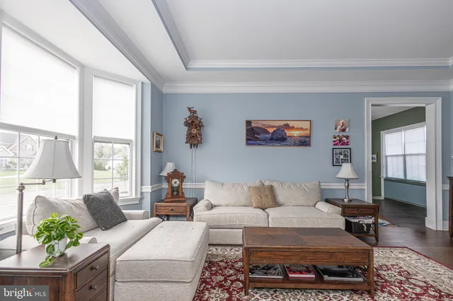a view of a workspace with bookshelf and a window