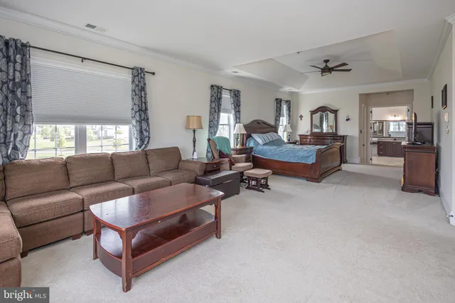 a spacious bathroom with a tub sink and mirror
