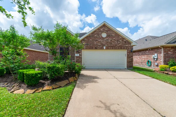 a front view of a house with a yard and a garage