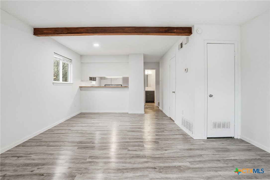 922 North 7th Street Copperas Cove, TX 76522 - Photo 8 of 26 a view of a kitchen with wooden floor and a window