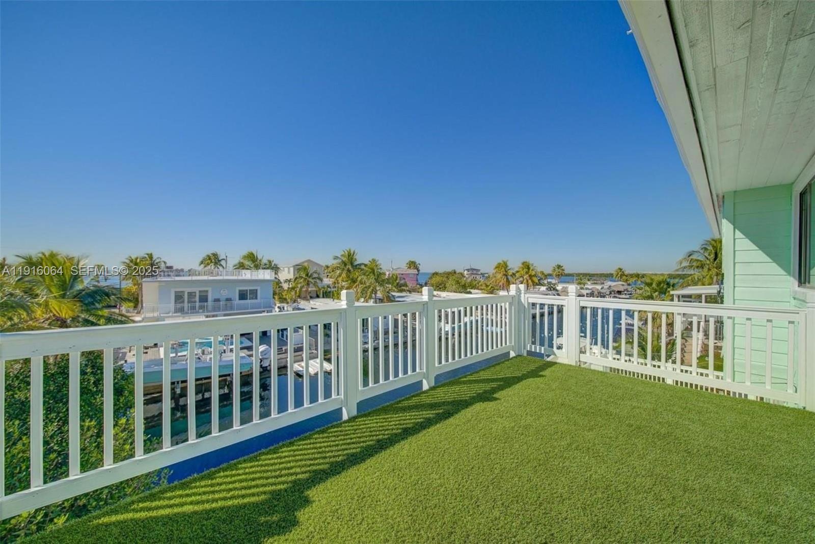 a view of a balcony with yard