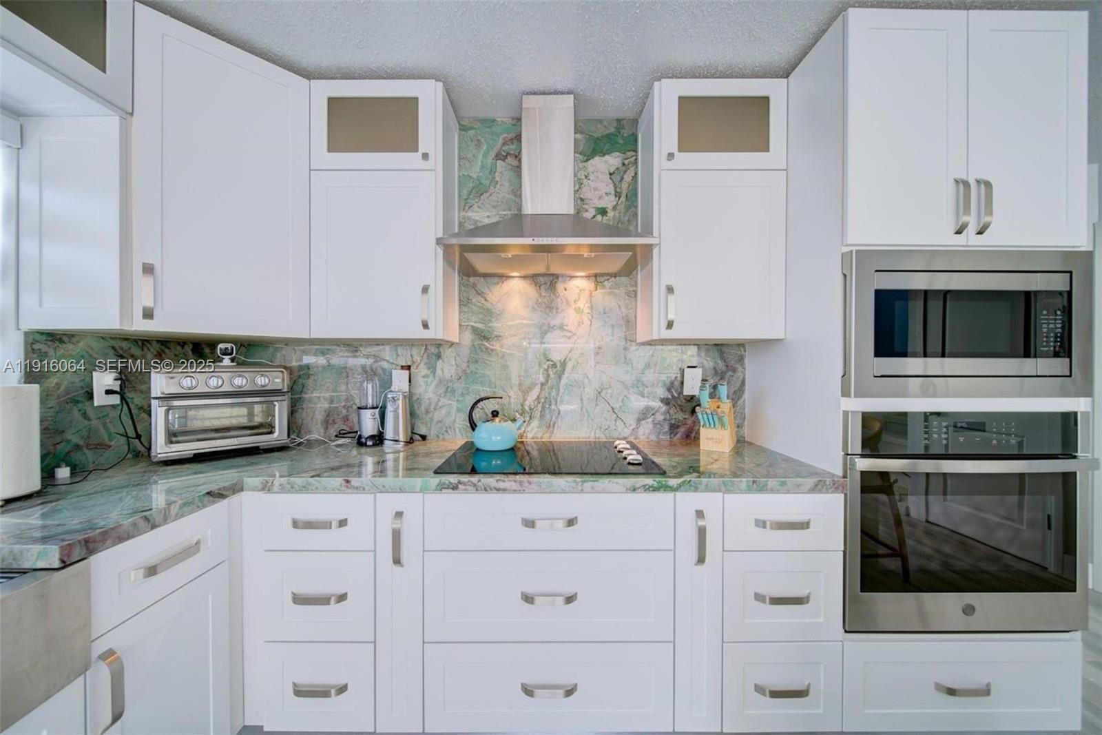 2 Snipe Road Key Largo, FL 33037 - Photo 13 of 41 a kitchen with granite countertop white cabinets and white stainless steel appliances