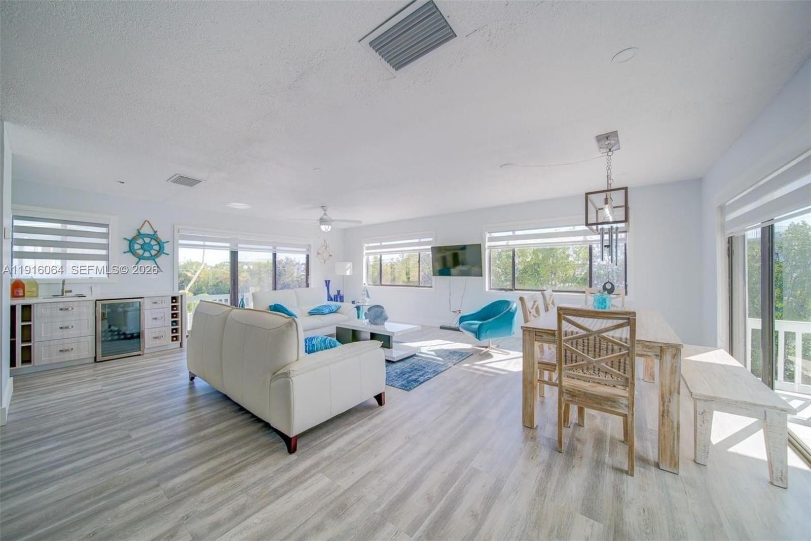 2 Snipe Road Key Largo, FL 33037 - Photo 16 of 45 a living room with fireplace furniture and a wooden floor