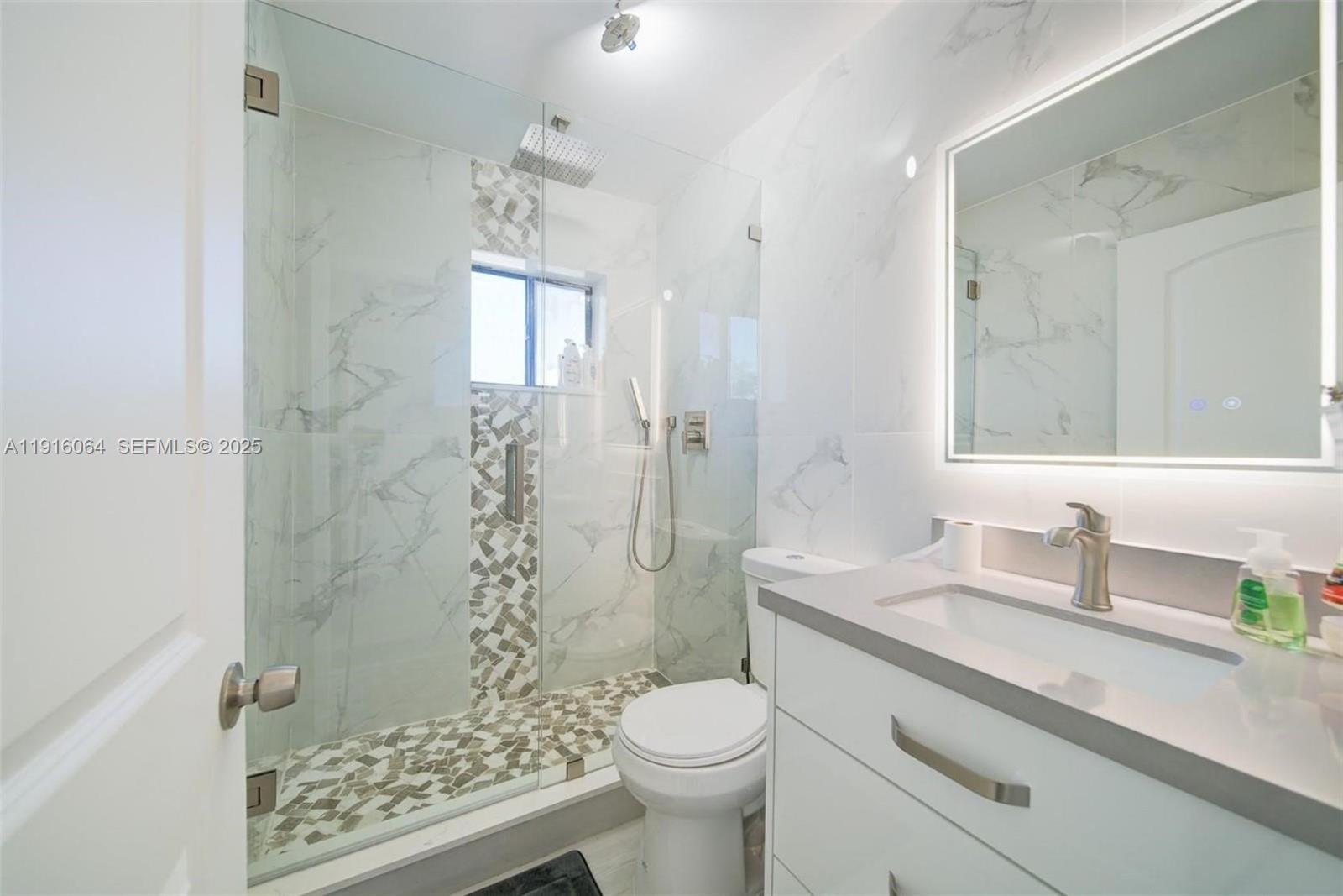 2 Snipe Road Key Largo, FL 33037 - Photo 18 of 41 a bathroom with a sink toilet and shower