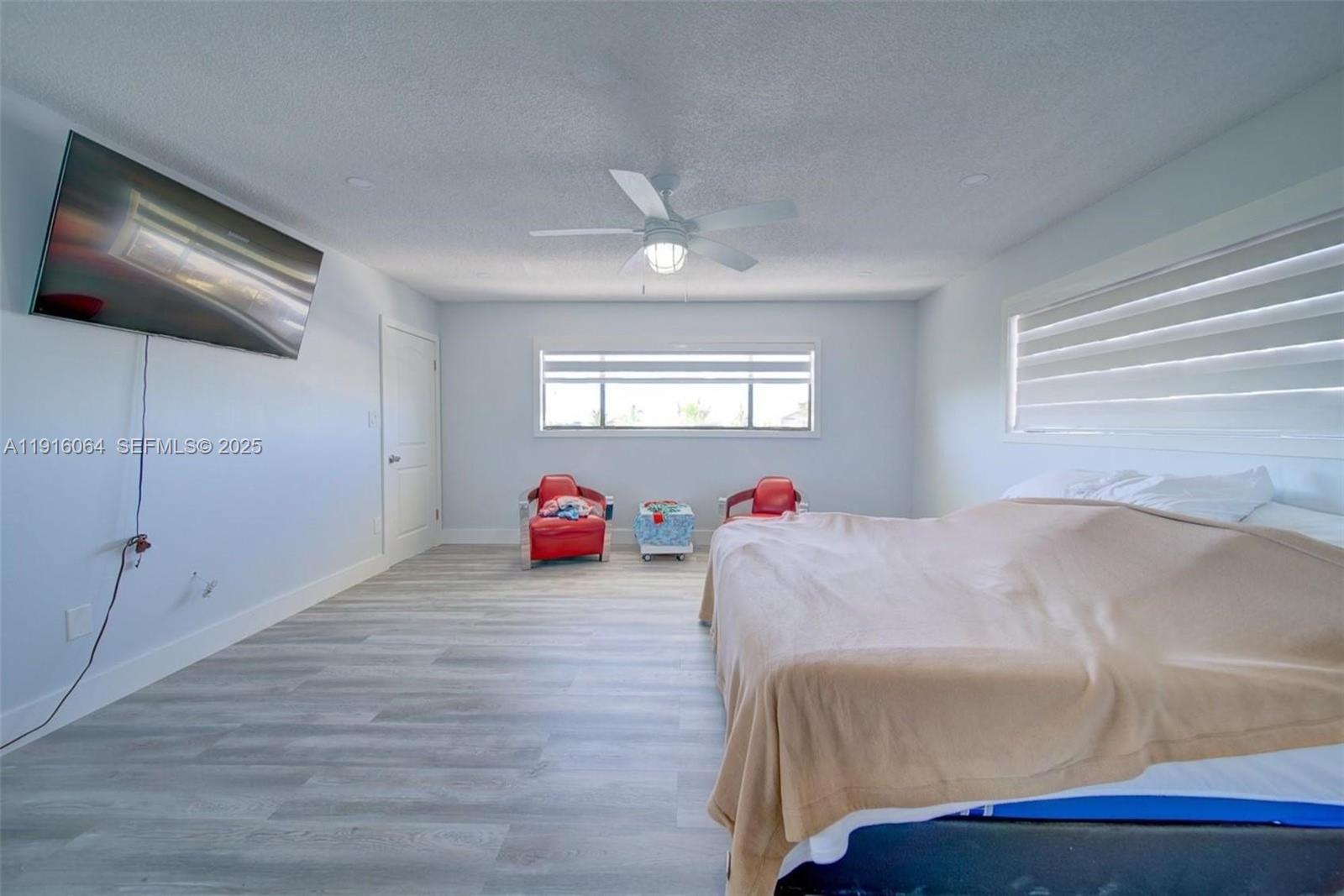 2 Snipe Road Key Largo, FL 33037 - Photo 25 of 41 a bedroom with a bed and a chandelier