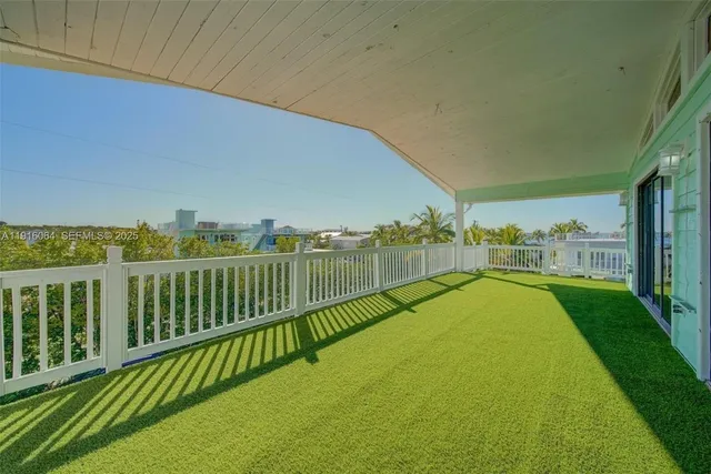 a view of a balcony with yard