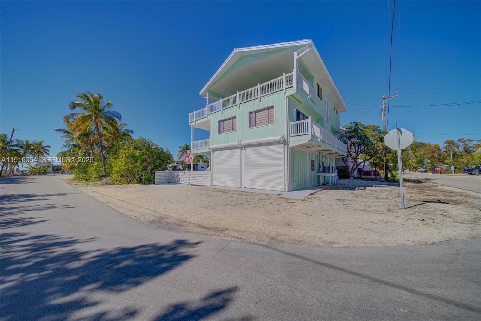 2 Snipe Road Key Largo, FL 33037 - Photo 31 of 45 a front view of a house with a yard and garage