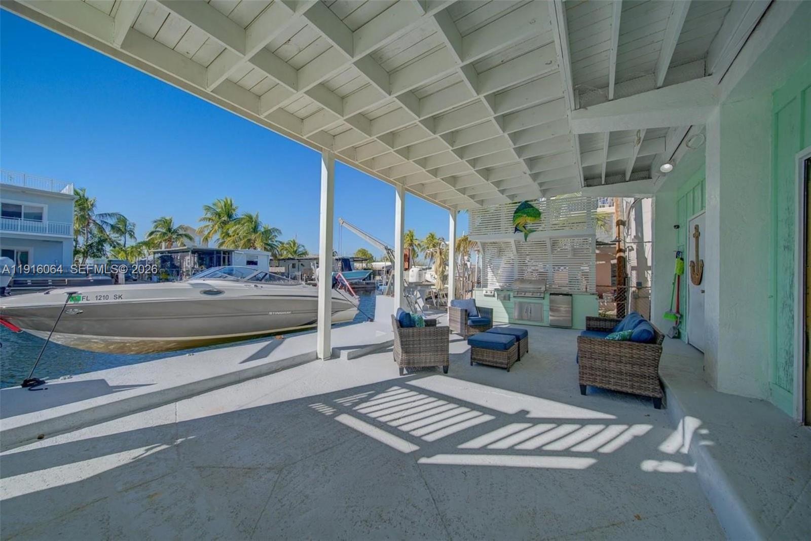 2 Snipe Road Key Largo, FL 33037 - Photo 4 of 45 a living room with furniture and a chandelier