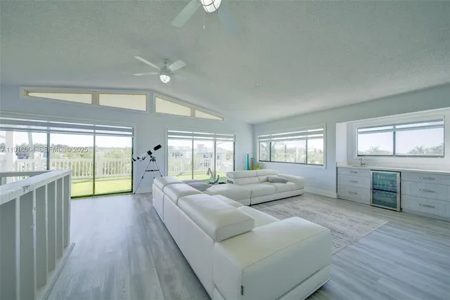 a living room with furniture and large windows