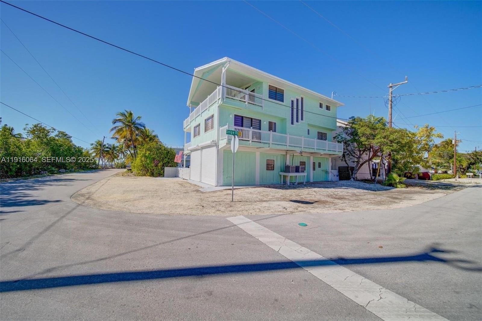 2 Snipe Road Key Largo, FL 33037 - Photo 7 of 41 a front view of a house with a yard