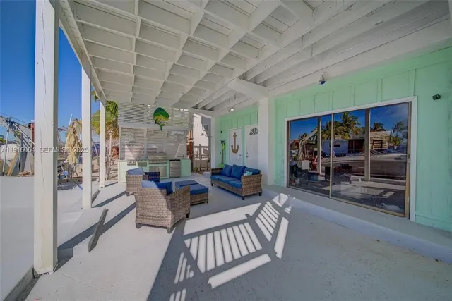 a living room with furniture a couch and a ceiling fan