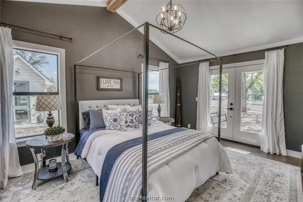 a bedroom with a large bed and a window