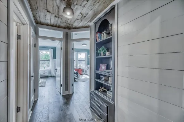 a hall way with furniture and wooden floor