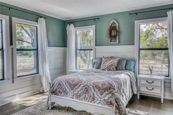 a bedroom with a large bed and a window