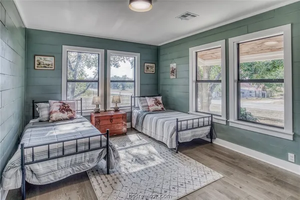 a bedroom with bed and large window