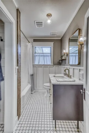 a bathroom with a sink a toilet and mirror