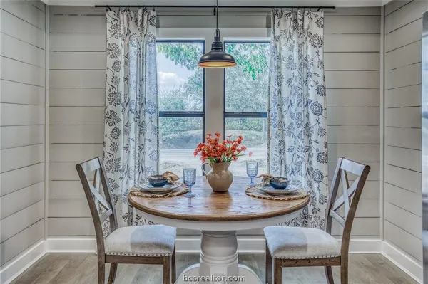 a view of a dining room with furniture and window